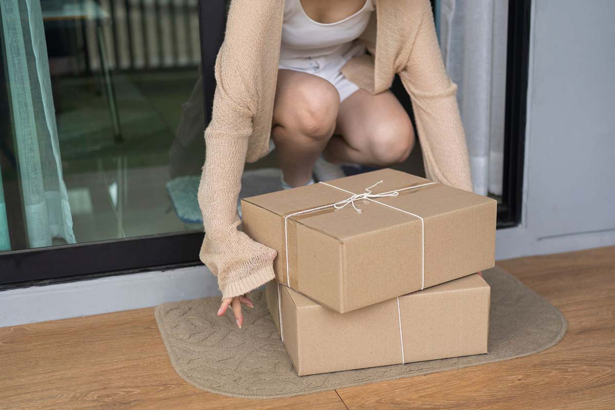 Woman Pick up the Parcel Box from contactless Door Delivery