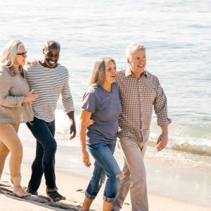 Seniors enjoying benefits while walking in the beach