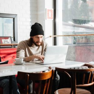 Person browsing the internet using free wifi in cafe restaurant