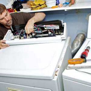 Handy Man fixing a dryer machine