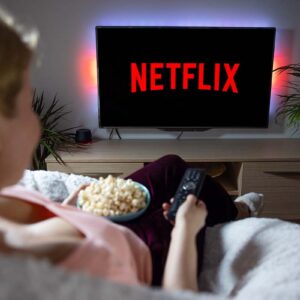 Canadian woman watching TV at home with Netflix logo on the screen