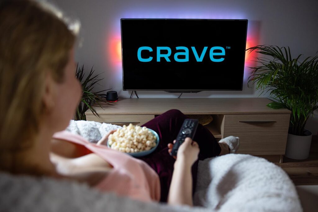 Canadian woman watching TV at home with Crave logo on the screen