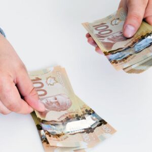 Man counting Canadian dollar image