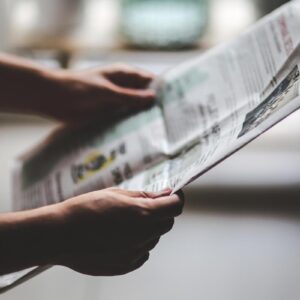 Person searching on newspaper obituaries in Canada