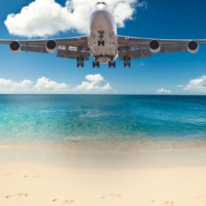 Airplane flying with a beautiful beach background