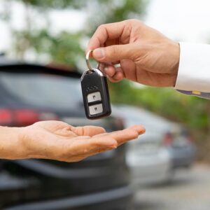 car dealer gives the car key with the car