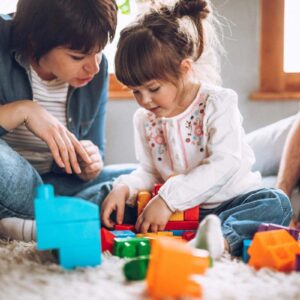 Parent and daughter playing together
